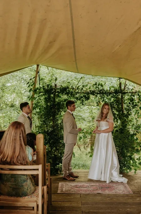 A celebrant stood in a teepee with the bride and groom