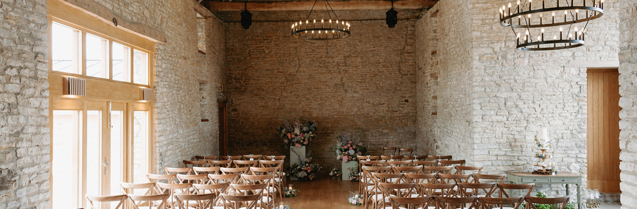 A photograph of the inside of Tockington Barn wedding venue - all set up for a wedding ceremony.