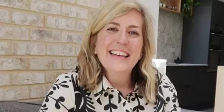 A woman sat in a chair smiling