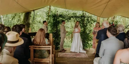 A celebrant stood in a teepee with the bride and groom