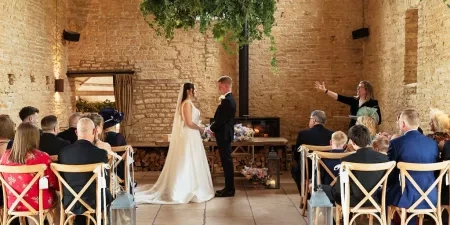 A photo of a couple being presented to their guests at a wedding ceremony at Old Gore Barn with Sam White Celebrant.
