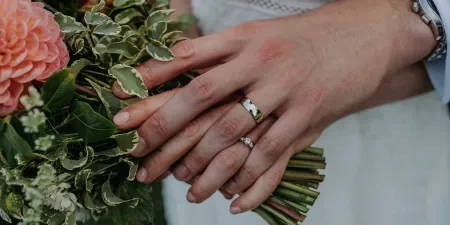 A photo of a couple with their wedding rings and the bouquet at Noah's Pond in Somerset.