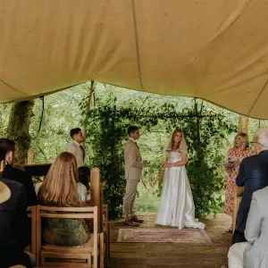 A celebrant stood in a teepee with the bride and groom