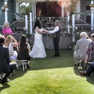 A man and woman taking part in a hand fasting cerfemony