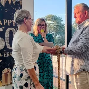 A man and woman holding hands facing each other