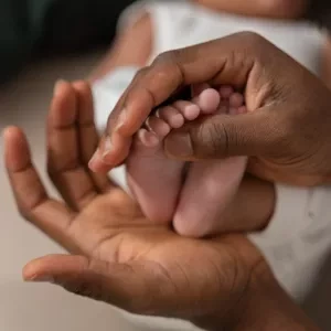 A woman holding a pair of baby feet