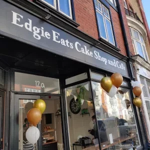A shop front with balloons outside