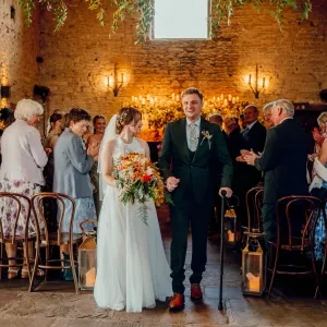 A photo of the couple walking back down the aisle after a wedding ceremony with Sam White Celebrant at Cripps Barn.