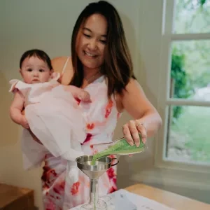 A close up of a baby naming ceremony with a sand blending ritual.